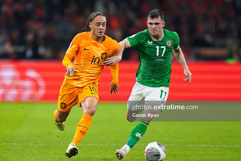 Jason Knight of Republic of Ireland holds off Xavi Simons of Holland