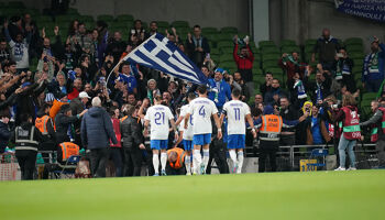 Greece fans at the Aviva Stadium celebrate Giorgios Giakoumakis' opening goal.
