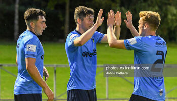 UCD's Colm Whelan is congratulated by team mates Paul Doyle and Liam Kerrigan.