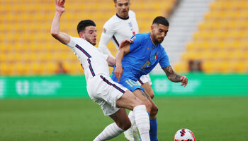 Italy's Lorenzo Pellegrini is challenged by former senior Republic of Ireland international Declan Rice as ex-Ireland under-21 international Jack Grealish looks on during England’s UEFA Nations League against Italy at Molineux in June 2022