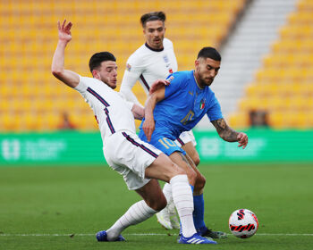 Italy's Lorenzo Pellegrini is challenged by former senior Republic of Ireland international Declan Rice as ex-Ireland under-21 international Jack Grealish looks on during England’s UEFA Nations League against Italy at Molineux in June 2022
