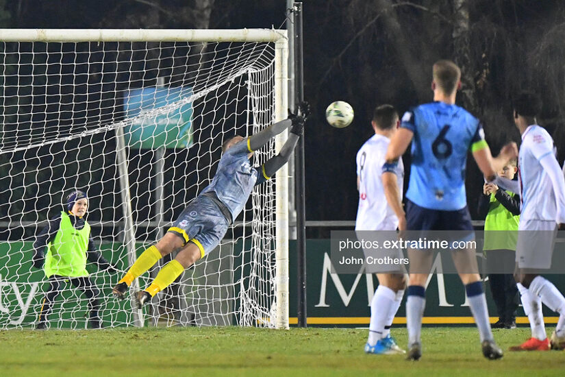 Drogheda keeper Colin McCabe turns Jack Keaney's effort round the post.