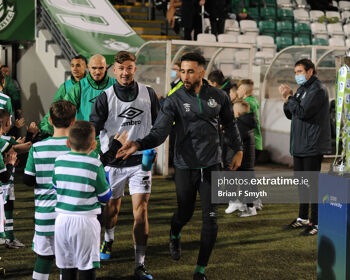 Shamrock Rovers captain Roberto Lopes greets a mascot as he takes the field at Tallaght Stadium.