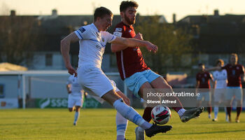 Sam Todd of UCD with Conor Drinan of Cobh Ramblers.