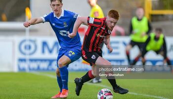 Longford Town FC's AODH DERVIN and Waterford FC's John Martin, tussle for the ball.