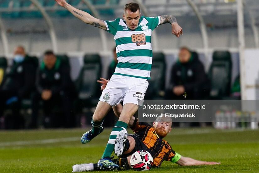 Chris Shields (c) of Dundalk FC tackles the ball away from Seán Kavanagh of Shamrock Rovers.