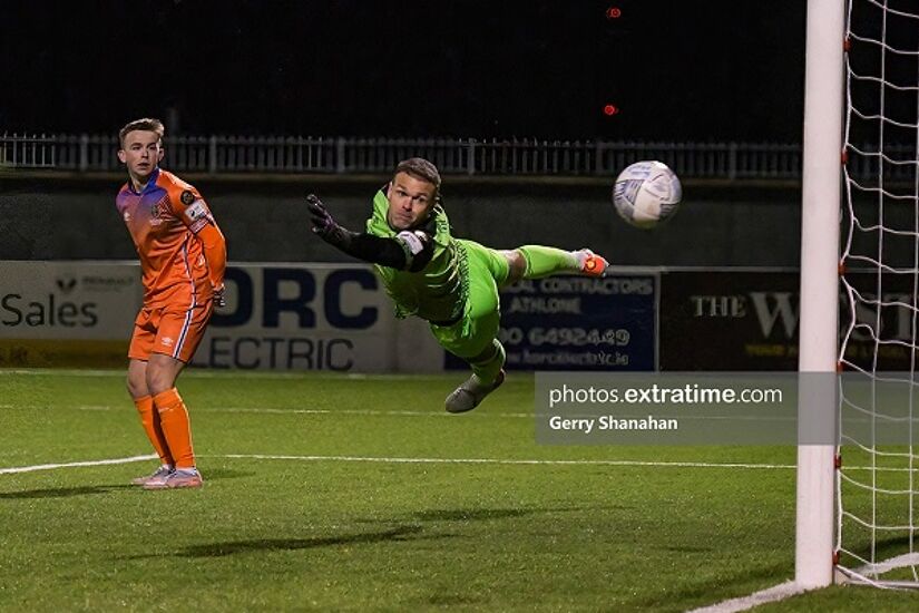 Brian Murphy dives but he can't keep Stephen Kenny's shot out of the net during Waterford's 5-2 win over Athlone Town at Lissywollen on Friday, 18 February 2022.