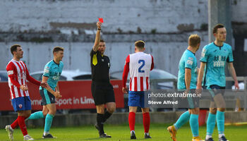 Charlie Fleming receives a red card from referee Declan Toland