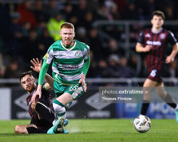 Darragh Nugent of Shamrock Rovers FC is fouled by Jordan Flores of Bohemian FC during the SSE Airtricity Men's Premier Division match between Shamrock Rovers FC and Bohemian FC at Tallaght Stadium, Dublin on March 29, 2024