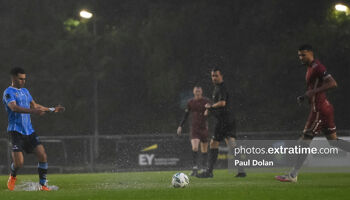 Evan Osam (left) splashing through the UCD Bowl pitch last Friday