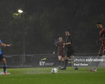 Evan Osam (left) splashing through the UCD Bowl pitch last Friday