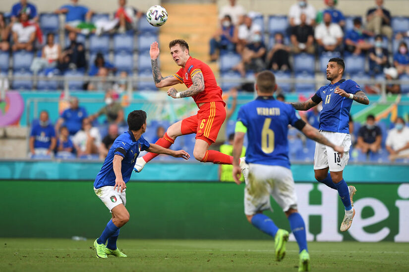 Joe Rodon of Wales wins a header whilst under pressure from Matteo Pessina and Emerson of Italy during the UEFA Euro 2020 Championship Group A match between Italy and Wales