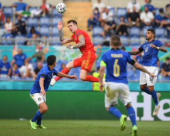 Joe Rodon of Wales wins a header whilst under pressure from Matteo Pessina and Emerson of Italy during the UEFA Euro 2020 Championship Group A match between Italy and Wales