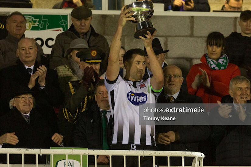President Michael D Higgins (left) watches Dundalk captain Brian Gartland lift the President's Cup in 2019