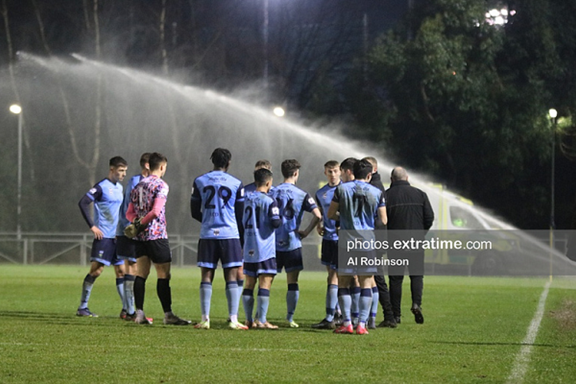 UCD look on as their game against Shelbourne is interrupted by the sprinkler system at the Bowl on Friday, 28 February 2022.