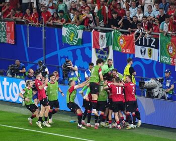 Georges Mikautadze of Georgia celebrates with teammates after scoring his team's second goal from a penalty kick during the UEFA EURO 2024 group stage match between Georgia and Portugal at Arena AufSchalke on June 26 2024, in Gelsenkirchen, Germany.