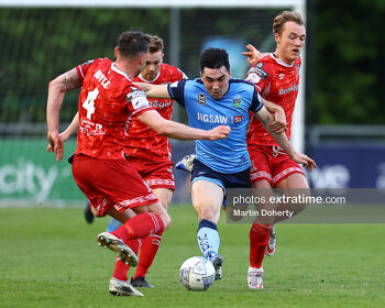 Liam Kerrigan of UCD tackled by Andy Boyle of Dundalk FC and Greg Sloggett of Dundalk FC