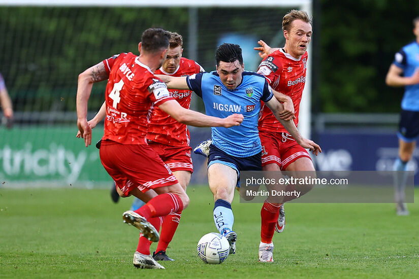 Liam Kerrigan of UCD tackled by Andy Boyle of Dundalk FC and Greg Sloggett of Dundalk FC