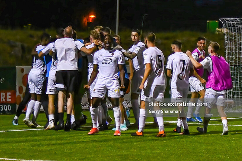 Waterford palyers surround their goalkeeper, Paul Martin, after their penalty shootout win over Athlone Town