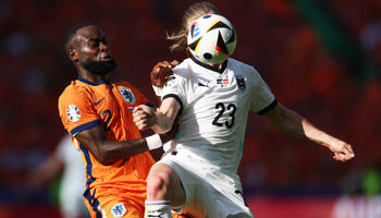 Lutsharel Geertruida of the Netherlands battles for possession with Patrick Wimmer of Austria (obscured) during the UEFA EURO 2024 group stage match between Netherlands and Austria at Olympiastadion on June 25, 2024 in Berlin