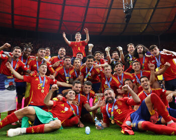 Players of Spain pose for a photo with the UEFA Euro 2024 Henri Delaunay Trophy as they celebrate in front of their fans after defeating England during the UEFA EURO 2024 final match between Spain and England at Olympiastadion on July 14, 2024 in Berlin