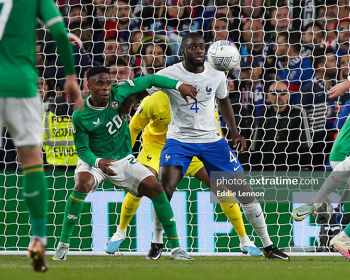 Chiedozie Ogbene holds off France's Dayot Upamecano during a Euro 2024 qualifier in the Aviva Stadium.