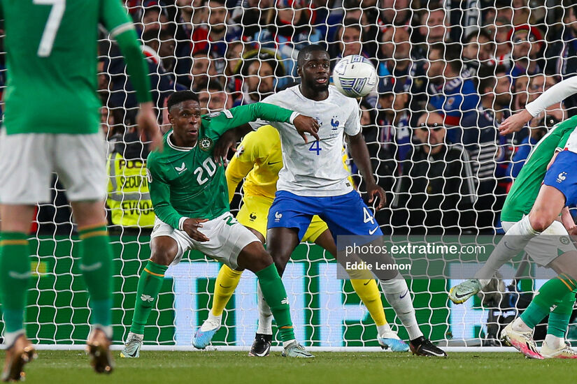 Chiedozie Ogbene holds off France's Dayot Upamecano during a Euro 2024 qualifier in the Aviva Stadium.