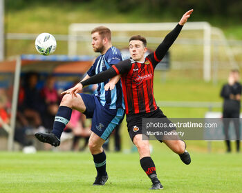 Gareth McCaffrey of St Mochta's challenged by Dylan Cashin of Malahide United