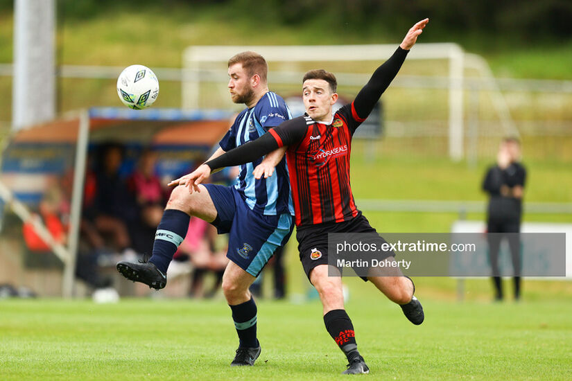 Gareth McCaffrey of St Mochta's challenged by Dylan Cashin of Malahide United