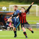 Gareth McCaffrey of St Mochta's challenged by Dylan Cashin of Malahide United