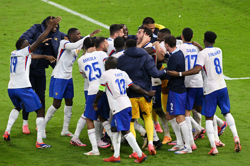 Theo Hernandez of France celebrates with teammates after scoring the team's fifth and winning penalty in the penalty shoot out following the UEFA EURO 2024 quarter-final match between Portugal and France at Volksparkstadion on July 05, 2024 in Hamburg