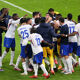 Theo Hernandez of France celebrates with teammates after scoring the team's fifth and winning penalty in the penalty shoot out following the UEFA EURO 2024 quarter-final match between Portugal and France at Volksparkstadion on July 05, 2024 in Hamburg