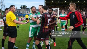 Referee Rob Harvey in yellow looking to calm things down as Rovers and Bohs players have a rush of blood to the head after some trouble in the Hoops penalty area