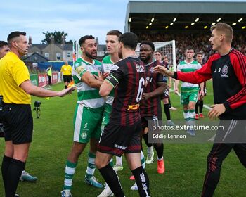 Referee Rob Harvey in yellow looking to calm things down as Rovers and Bohs players have a rush of blood to the head after some trouble in the Hoops penalty area