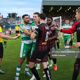 Referee Rob Harvey in yellow looking to calm things down as Rovers and Bohs players have a rush of blood to the head after some trouble in the Hoops penalty area