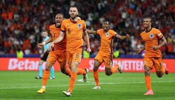 Stefan de Vrij of the Netherlands celebrates scoring his team's first goal with teammate Xavi Simons during the UEFA EURO 2024 quarter-final match between Netherlands and Turkey in Berlin's Olympiastadion