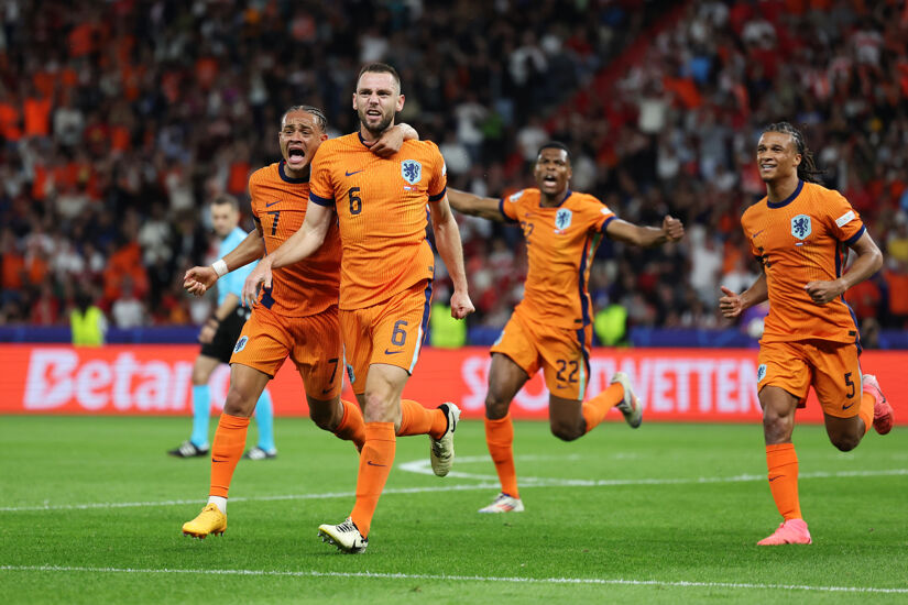 Stefan de Vrij of the Netherlands celebrates scoring his team's first goal with teammate Xavi Simons during the UEFA EURO 2024 quarter-final match between Netherlands and Turkey in Berlin's Olympiastadion