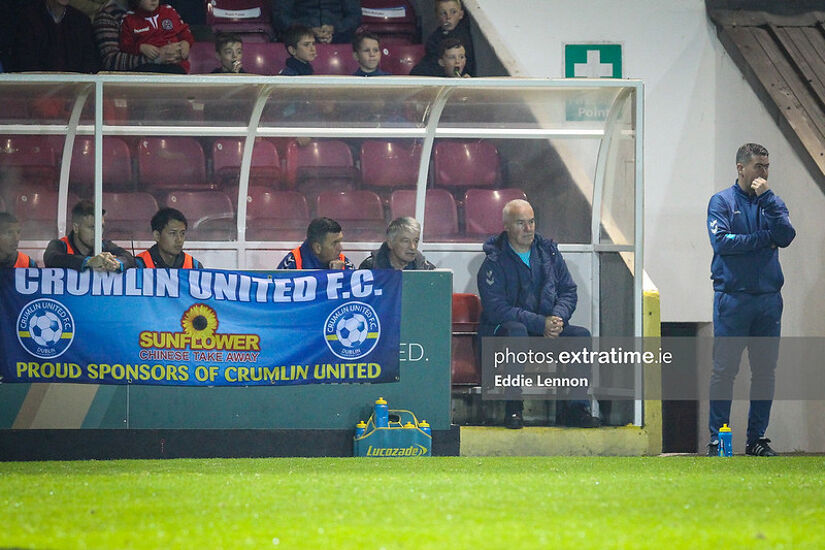 Loughran (right on bench) took charge of Crumlin's FAI Cup quarter-final tie with Bohemians in 2019.