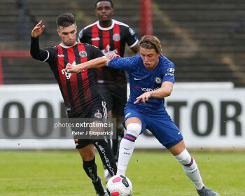 Conor Gallagher of Chelsea and Daniel Mandroiu challenge for the ball