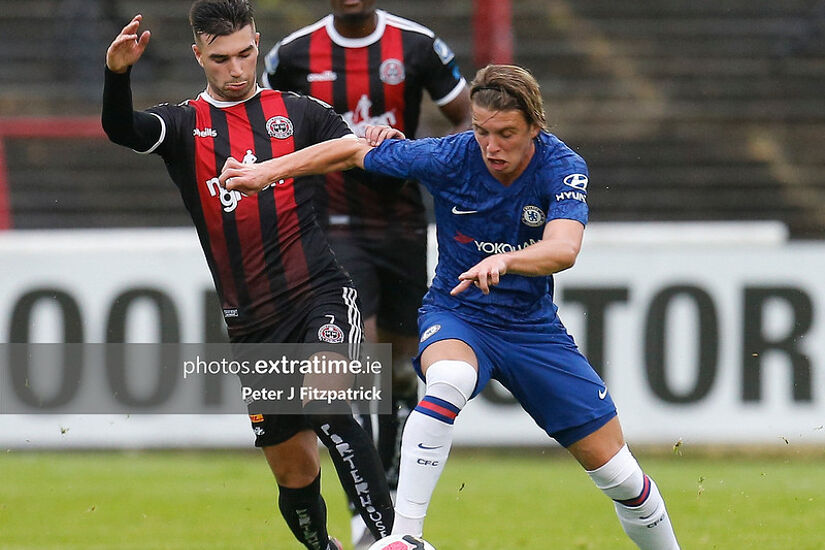 Conor Gallagher of Chelsea and Daniel Mandroiu challenge for the ball