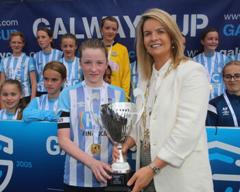 Salthill Devon's Ailbhe MacNeill receives the Cup from Mayor of Galway Clodagh Higgins after her team beat Wicklow in the Girls 2009 Cup Final
