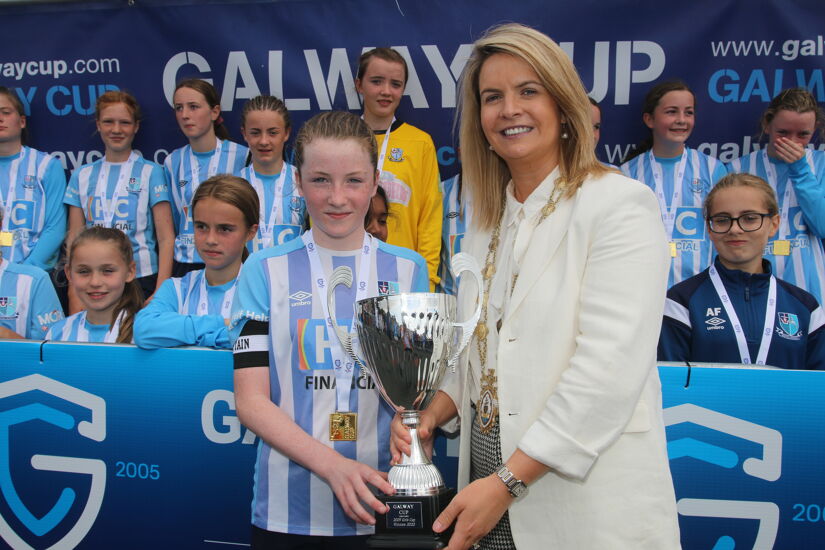 Salthill Devon's Ailbhe MacNeill receives the Cup from Mayor of Galway Clodagh Higgins after her team beat Wicklow in the Girls 2009 Cup Final