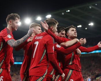 Neco Williams of Wales celebrates scoring his team’s second goal with team mates during the UEFA EURO 2024 Play-Offs Semi-final match between Wales and Finland at Cardiff City Stadium on March 21, 2024 in Cardiff, Wales.