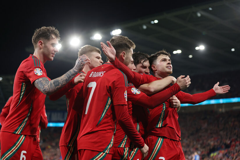 Neco Williams of Wales celebrates scoring his team’s second goal with team mates during the UEFA EURO 2024 Play-Offs Semi-final match between Wales and Finland at Cardiff City Stadium on March 21, 2024 in Cardiff, Wales.