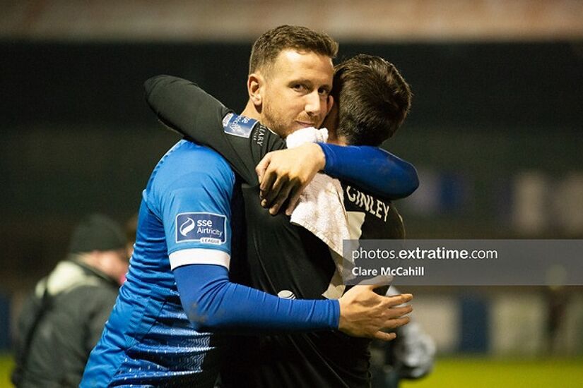 Shane McEleney embraces goalkeeper Mark McGinley following the 1-0 win over Waterford.