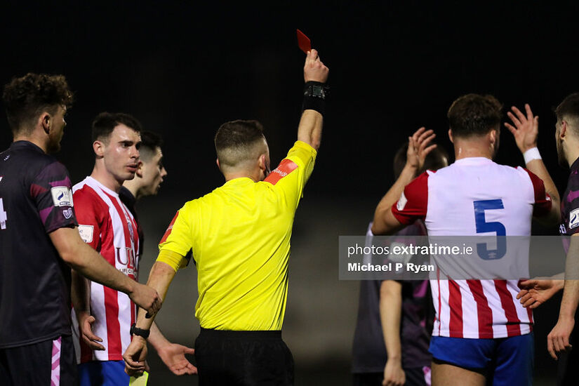 Clyde O'Connell of Treaty United, right, receives a red card from referee Jason Mannix.