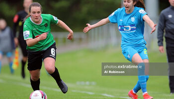 Lucy McCartan of Peamount United shoves Shauna Carroll of DLR Waves FC off the ball.