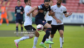 Ronan Coughlan challenged by Sligo Rovers' Lewis Banks and Greg Bolger