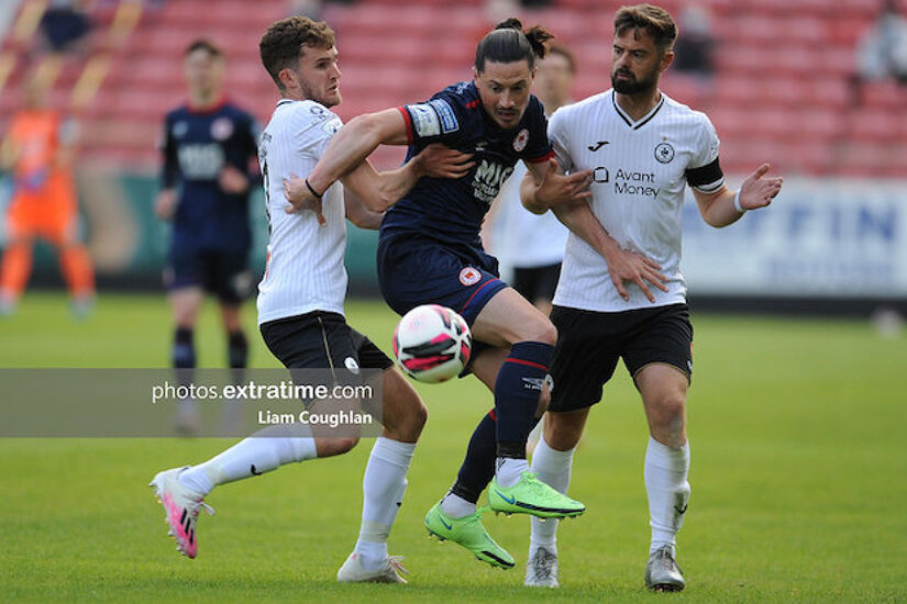 Ronan Coughlan challenged by Sligo Rovers' Lewis Banks and Greg Bolger