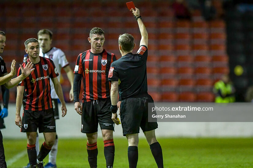 Referee Derek Tomney issues a red card to Longford Town FC's, Aaron Robinson, during the Longford Town v Dundalk FC, SSE Airtricity Premier Division match at Head in the Bishopsgate, Longford.